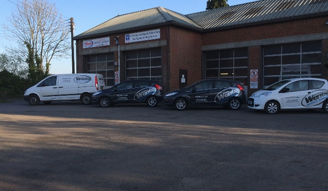 two cars outside wents service station